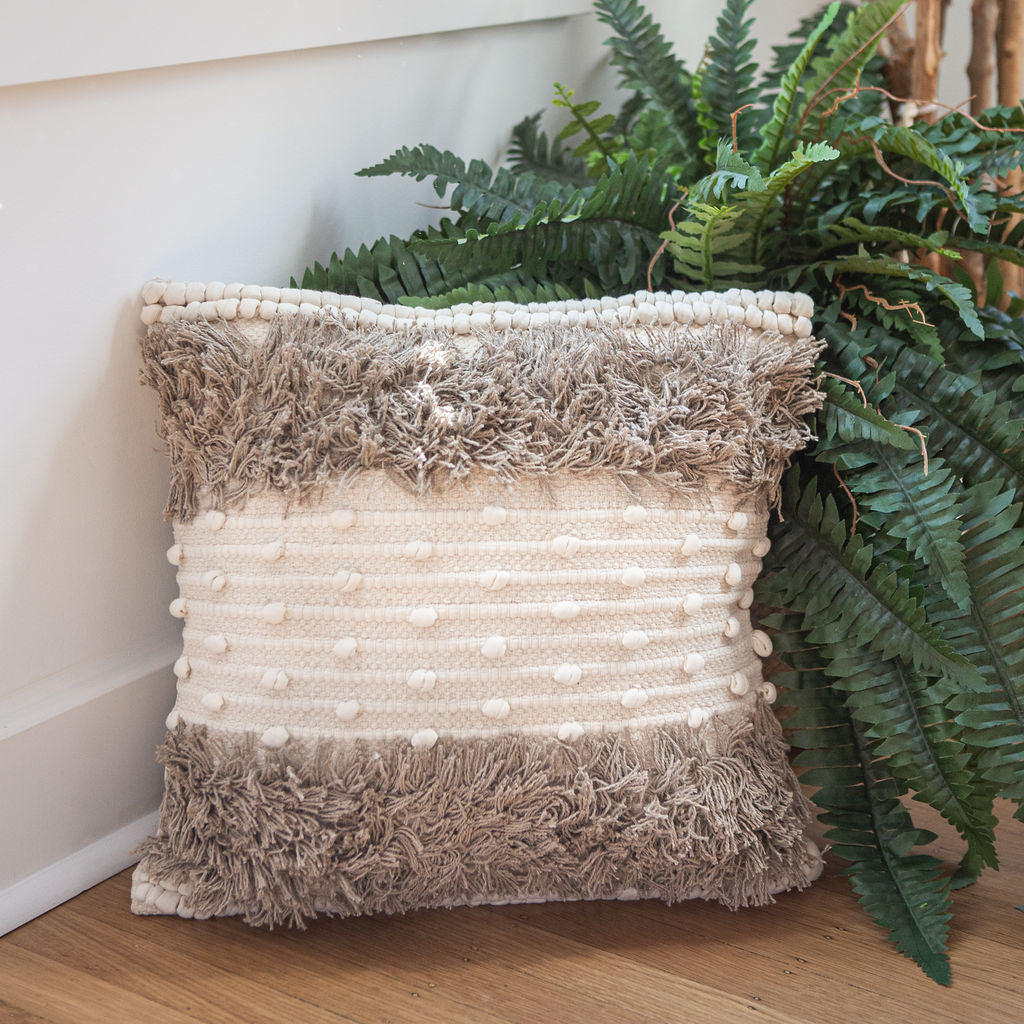 Aarohi chic throw pillow with planters in background to show different textures adding to the Bohemian vibe